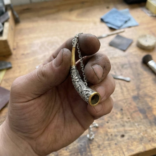Gjallarhorn Heirloom Norsk Horn Pendant - pendant held in the maker's hand