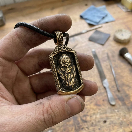 Odin Allfather Runic Face Pendant - solid brass pendant held in craftsman hand