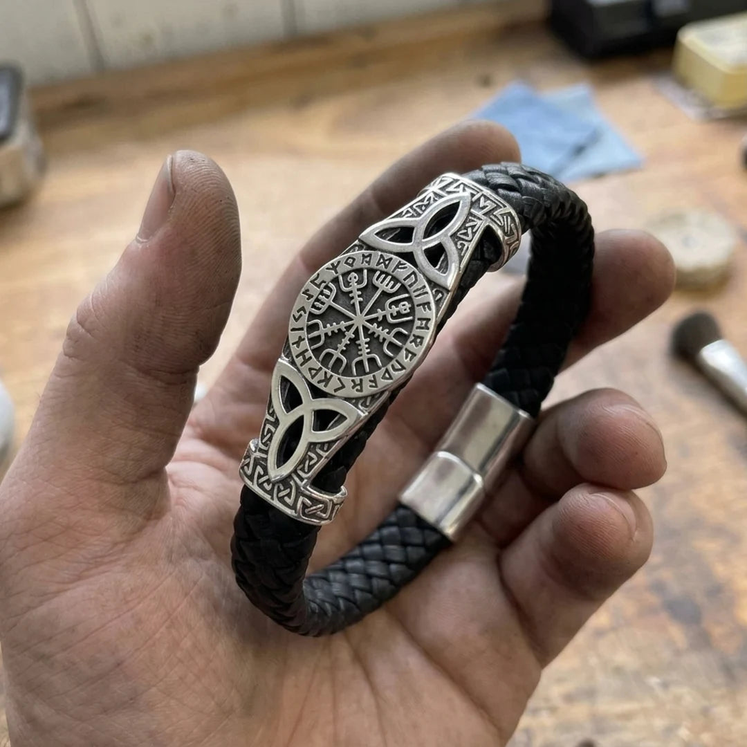 Path Of The North Leather Cord Bracelet - held in the maker's hand in solid sterling silver